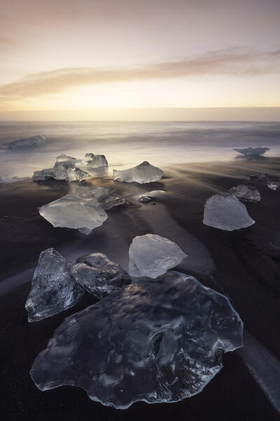 the ice blocks of the famous Black Sand Beach, taken during an autumn sunrise, Jokusarloon, Iceland, Europe
