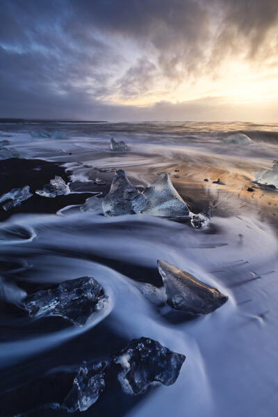 the ice blocks of the famous Black Sand Beach, taken during an autumn sunrise, Jokusarloon, Iceland, Europe