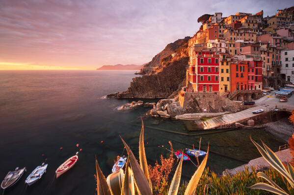 a long exposure to capture the warm light of sunset at Riomaggiore, Cinque Terre, Liguria, Italy, Europe