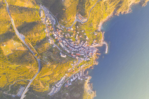 aerial vertical view taken by drone of Riomaggiore, beautiful village of Cinque Terre, during a sunny day, La Spezia, Italy, Europe