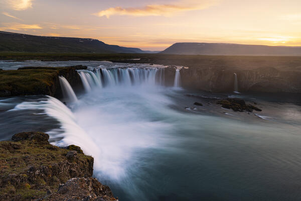 a long exposure to capture the sunset at Godafoss waterfall during a summer day, Iceland, Europe