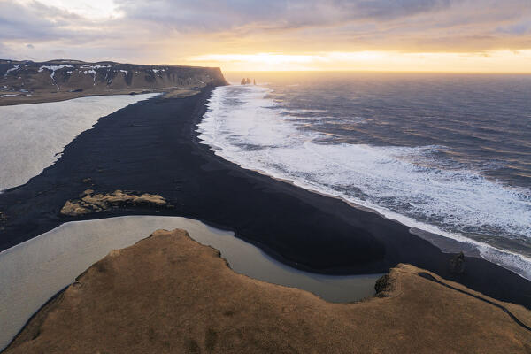 aerial view of the famous Reynisfjara beach and the Vik i Myrdal sea stacks in the background, Vik i Myrdal, Iceland