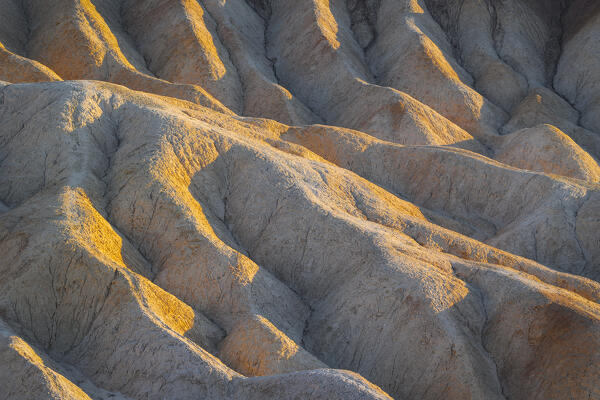 a beautiful sunrise light envelope the rock formation at Zabriskie Point, Death Valley National Park, California, United States of America
