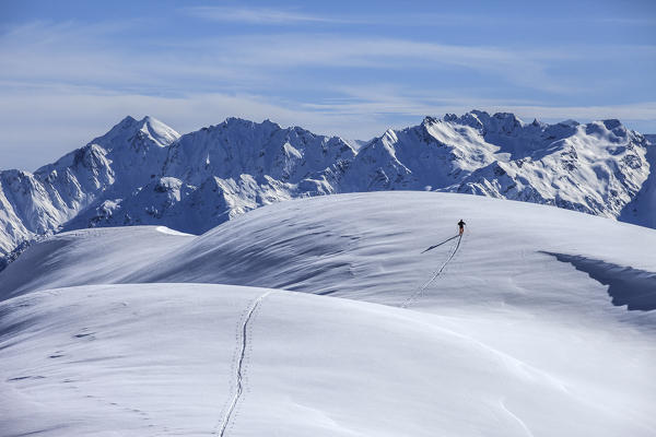 Mountaineering on the Dosso Liscio mountain, in the background the Orobie alps, Lombardy, Italy