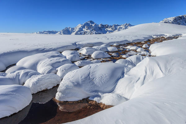 Snow forms in Campagneda, in the background Disgrazia mountain, Malenco valley, Lombardy, Italy