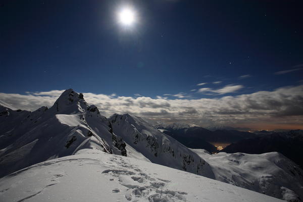 Full moon at Salmurano mountain on the Orobie alps, Lombardy, italy