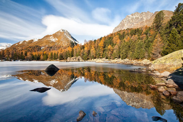 Switzerland, reflection at Saoseo lake on the Campo valley in autumn