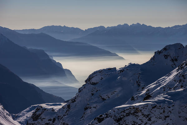 Fogs above the Chiavenna valley from high ridges. Retiche alps, Lombardy, taly