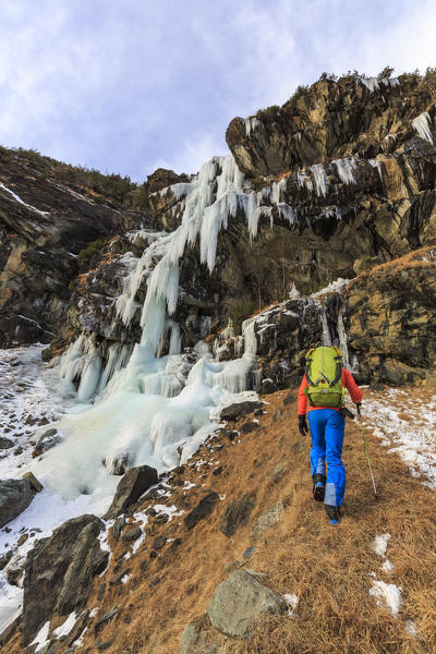 Mountaineer at the Specchi icefall (Cascata degli Specchi), Malenco Valley, Valtellina, Lombardy, province of Sondrio, Italy