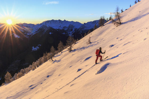 Ski mountaineer on steep slope towards Cima Rosetta, Gerola Valley, Sondrio province, Valtellina, Lombardy, Italy