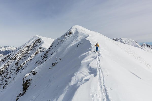 Ski mountaineer on snowy peak, Valgerola, Valtellina, province of Sondrio, Lombardy, Italy