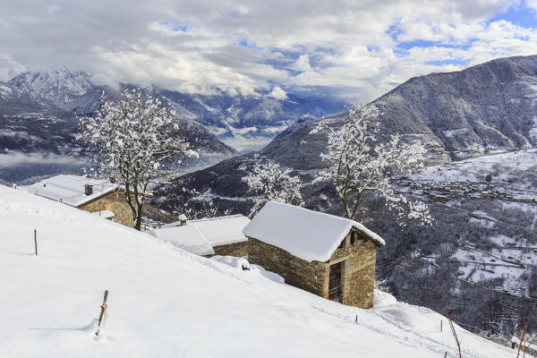 Log cabin on Monte Olano covered with snow, Valgerola, Valtellina, province of Sondrio, Lombardy, Italy
