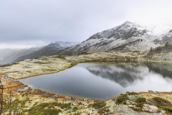 Porcile Lake after a snowfall in autumn, Val Lunga, Tartano Valley, Sondrio province, Valtellina, Lombardy, Italy