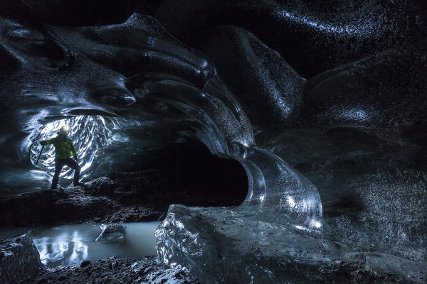 Hiker in an ice cave, Austurland, Iceland, Northern Europe
