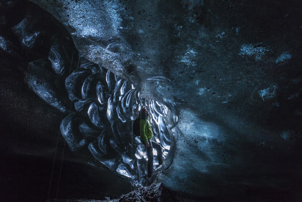 Man in an ice cave, Austurland, Iceland, Northern Europe