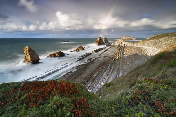 Sunset with rainbow at Playa de la Arnia, Boo de Pielagos, Cantabria, Spain, Iberian Peninsula, Western Europe