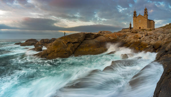 A man at sunset at Virxe da Barca sanctuary,  Muxia, A Coruna, Galcia, Spain, Iberian Peninsula, Western Europe