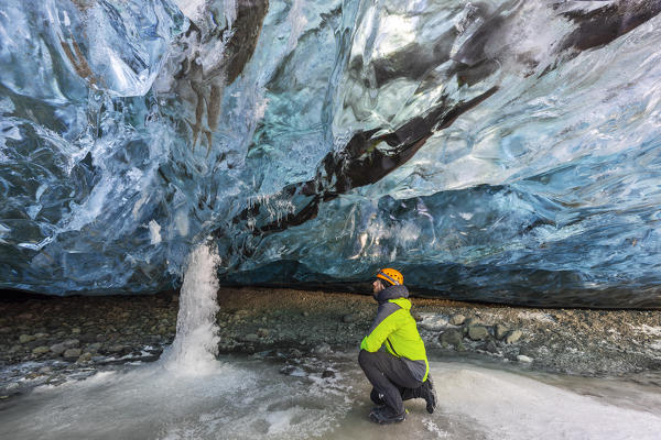 Man in an ice cave of Breidamerkurjokull, Austurland, Iceland, Northern Europe