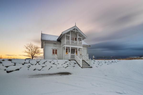 A White house at sunrise in Hamnoy, Moskenes, Moskenesoya, Nordland, Lofoten, Norway, Northern Europe