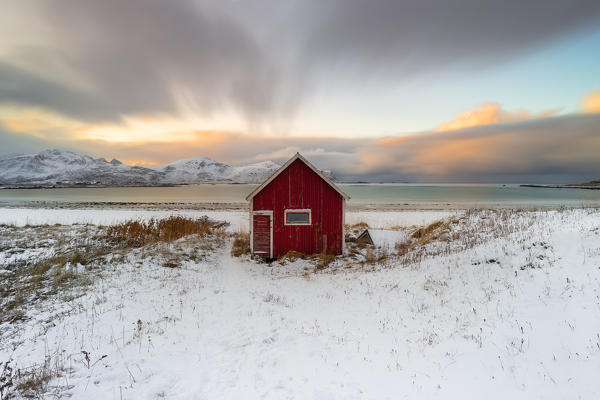 Red hut at Rambergstranda at sunset, Flakstadoya, Nordland, Lofoten, Norway, Northern Europe