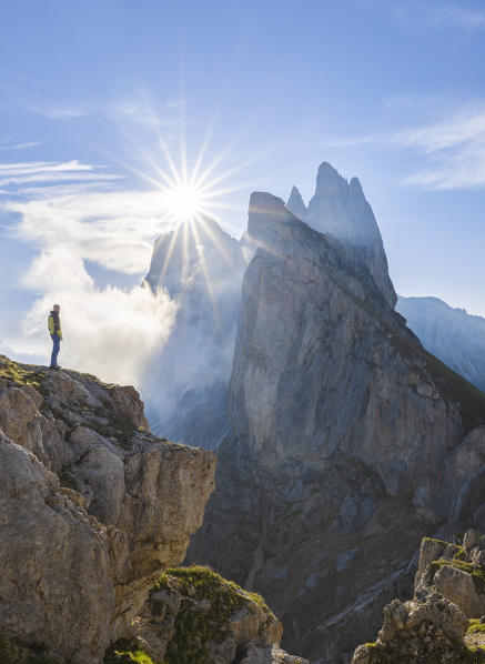 A man observes sunrise at Seceda, Gruppo delle Odle, Dolomiti di Gardena, Bolzano, Trentino Alto Adige, Italy, Southern Europe