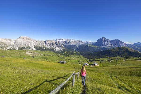 A woman observes mountains from Seceda, Gruppo delle Odle, Dolomiti di Gardena, Bolzano, Trentino Alto Adige, Italy, Southern Europe (MR)
