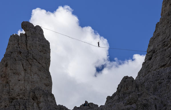 A man does slackline at Vajolet Towers, Catinaccio Group, Dolomiti di Gardena e di Fassa, Bozen, Trentino Alto Adige, Italy, Southern Europe