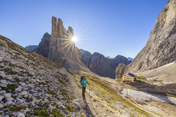 Rifugio Re Alberto 1 at Vajolet Towers and woman at sunrise, Gruppo del Catinaccio, Dolomiti di Gardena, Bolzano, Tires, Trentino Alto Adige, Italy, Southern Europe (MR)