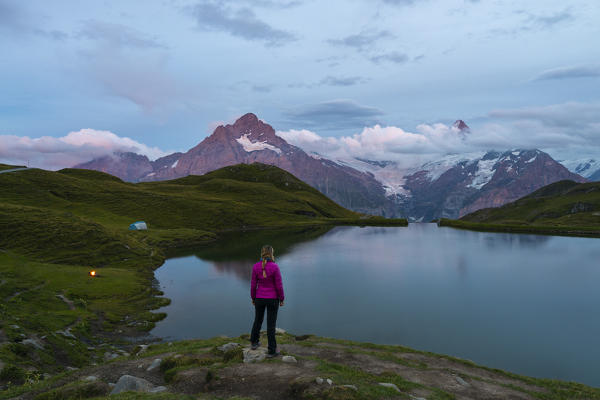 Twilight at Bachalpsee and a woman, Jungfrau region, Canton Berna, Oberland, Switzerland, Western Europe