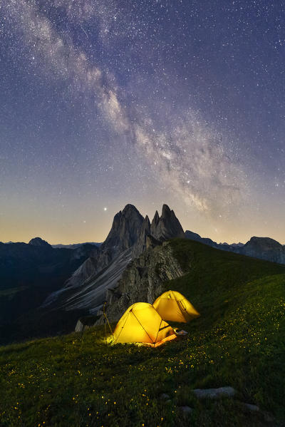 Milky way and tents over Grosse Fermeda at Seceda, Gruppo delle Odle, Dolomiti di Gardena, Bolzano, Trentino Alto Adige, Italy, Southern Europe
