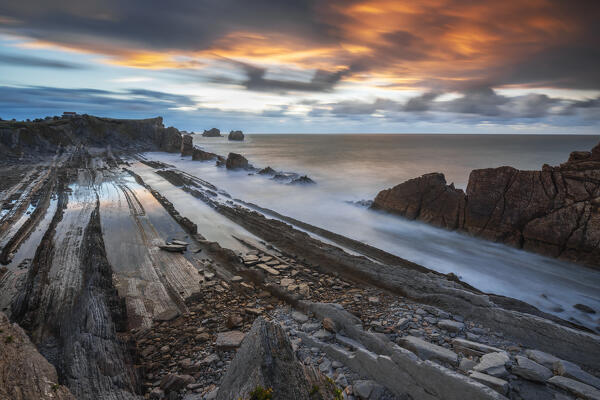 Colorful clouds during sunset at Playa de la Arnia, Boo de Pielagos, Cantabria, Spain, Iberian Peninsula, Western Europe