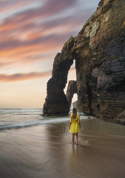 Woman walking at Playa de Las Catedrales at sunset, Ribadeo, Galicia, Spain, Iberian Peninsula, Western Europe