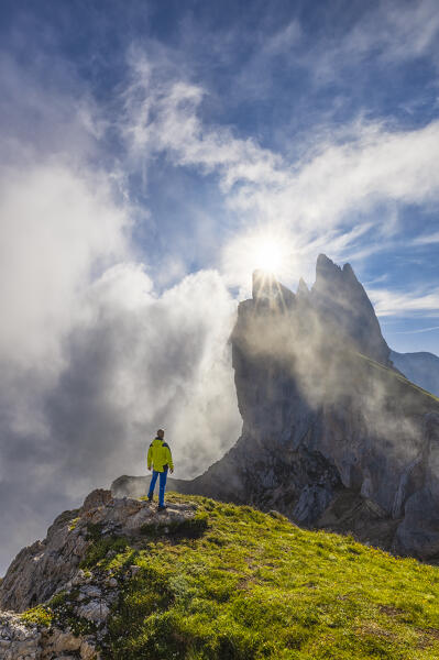 A man observes Seceda during sunrise, Gruppo delle Odle, Dolomiti di Gardena, Bolzano, Trentino Alto Adige, Italy, Southern Europe (MR)