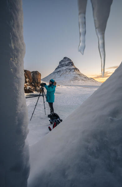 A photographer at Kirkjufell during sunrise, Grundarfjörður, Snæfellsnes peninsula, Vesturland region, Iceland, Northern Europe 
