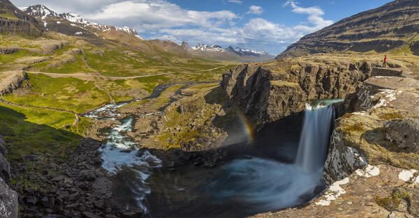 Person observes Folaldafoss waterfall and Berufjordur during summer, Austurland, Iceland, Northern Europe (MR)