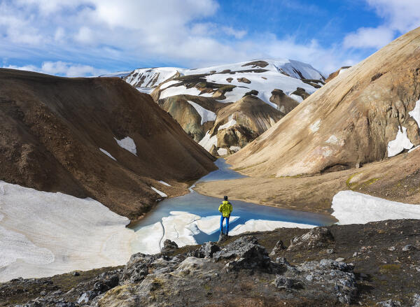 Aerial view of a man that observes Landmannalaugar mountains and canyon during summer, Landmannalaugar, Highlands, Iceland, Northern Europe (MR)