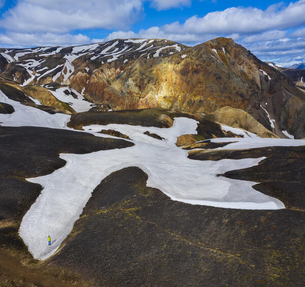 Aerial view of a man that observes Landmannalaugar mountains during summer, Landmannalaugar, Highlands, Iceland, Northern Europe (MR)
