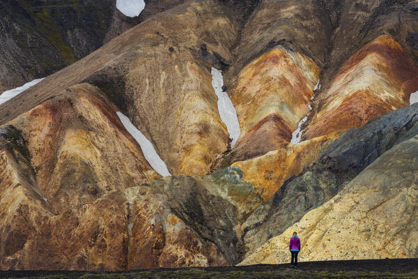 Woman observes Landmannalaugar mountains during summer, Landmannalaugar, Highlands, Iceland, Northern Europe (MR)