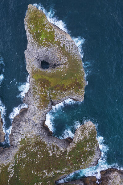 A cliff like a face at Area recreativa de Guadamia and Los Bufones de Pria at sunrise, Ribadesella, Asturias, Spain, Western Europe