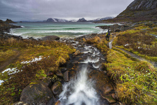 A man at Rorvikstranda beach in a moody day, Kabelvag, Vagan, Austagoy, Nordland, Lofoten, Norway, Northern Europe  (MR)