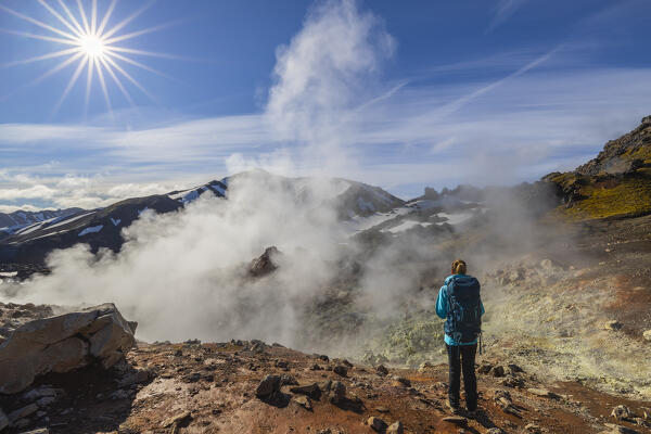 Tourist observes Landmannalaugar mountains and sulfate steam during summer, Landmannalaugar, Highlands, Iceland, Northern Europe (MR)