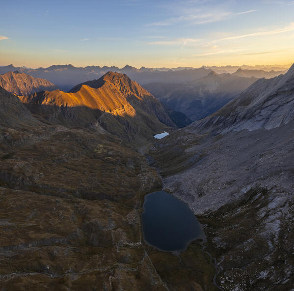 Aerial view of Lac Foreant at sunrise during summer, Col Agnel, Alpi Cozie, Cuneo, Provance, Piedmont, France, Italy, Southern Europe 