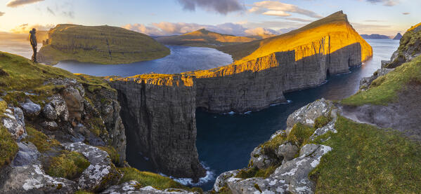 A trekker at Sørvagsvatn during sunset, Vagar, Faroe Islands, Denmark, Scandinavia