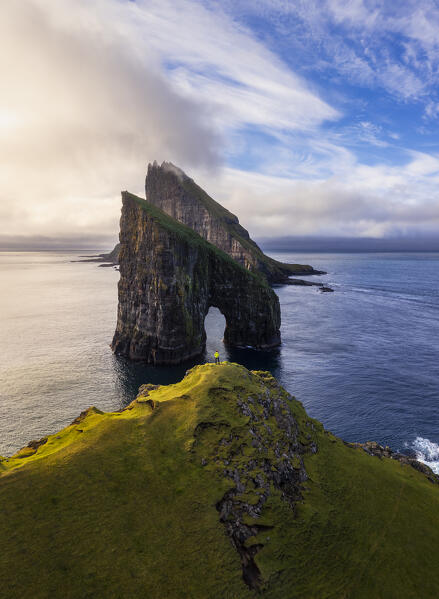 Aerial view of a person at Drangarnir at sunset, Vagar, Faroe Islands, Denmark, Scandinavia