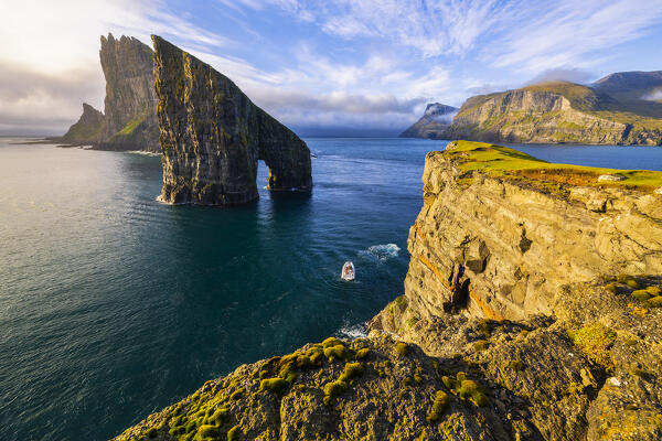 Drangarnir at sunset with boat of tourists, Vagar, Faroe Islands, Denmark, Scandinavia