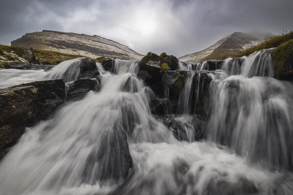 Nordanfyri Blamansjall and Husafjall mountains with a waterfall in the foreground near Gjogv, Sunda municipality, Eysturoy, Faroe Islands, Denmark, Scandinavia
