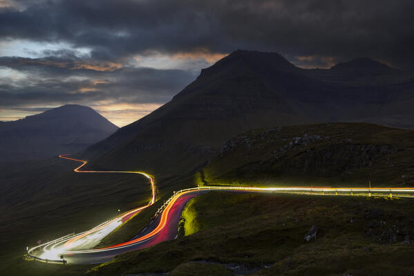 Mountain pass near Gjogv at dusk with car light trails, Gjogv, Sunda municipality, Eysturoy, Faroe Islands, Denmark, Scandinavia