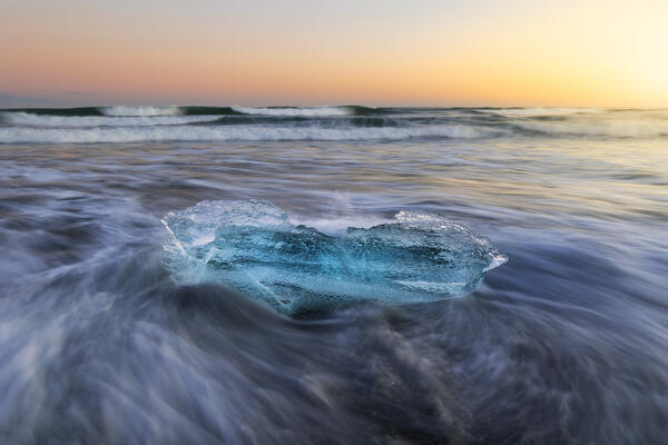 Block of ice at Diamon beach during sunset, Jökulsárlón, Diamond beach, Austurland, Iceland, Northern Europe