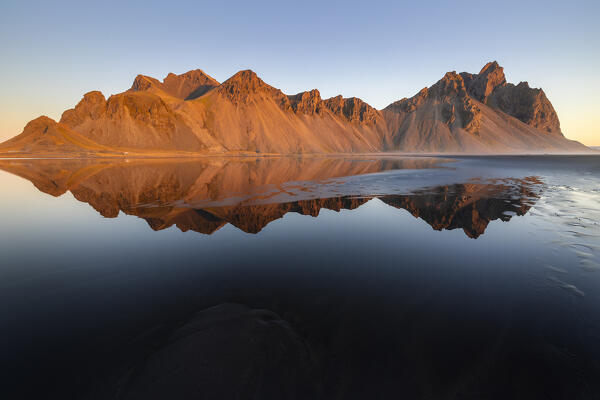 Vestrahorn reflected at sunrise, Stokksnes peninsula, Hofn, Austurland, Iceland, Northern Europe