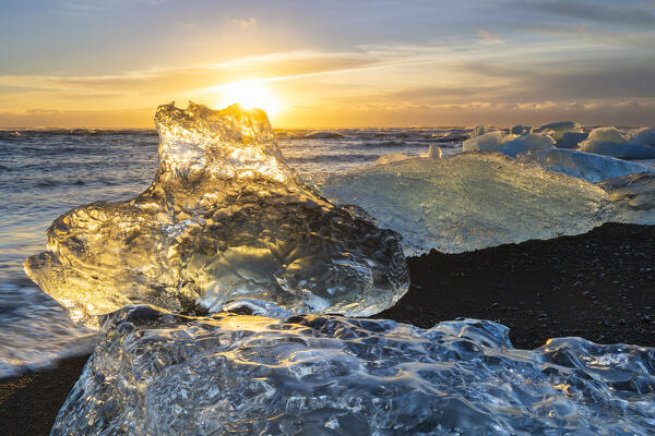 Block of ice at Diamon beach during sunrise, Jökulsárlón, Diamond beach, Austurland, Iceland, Northern Europe